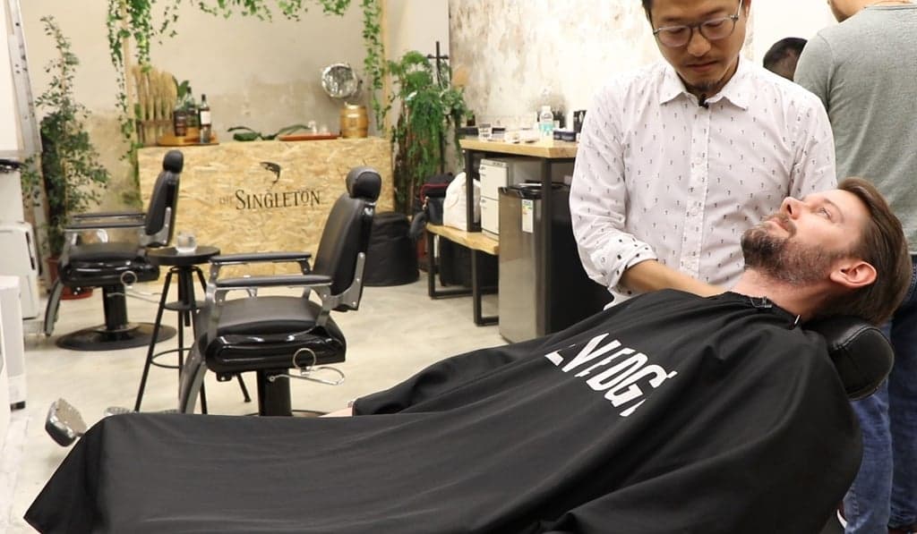 Fernando Viseu at work — barber at his previous shop in Hong Kong